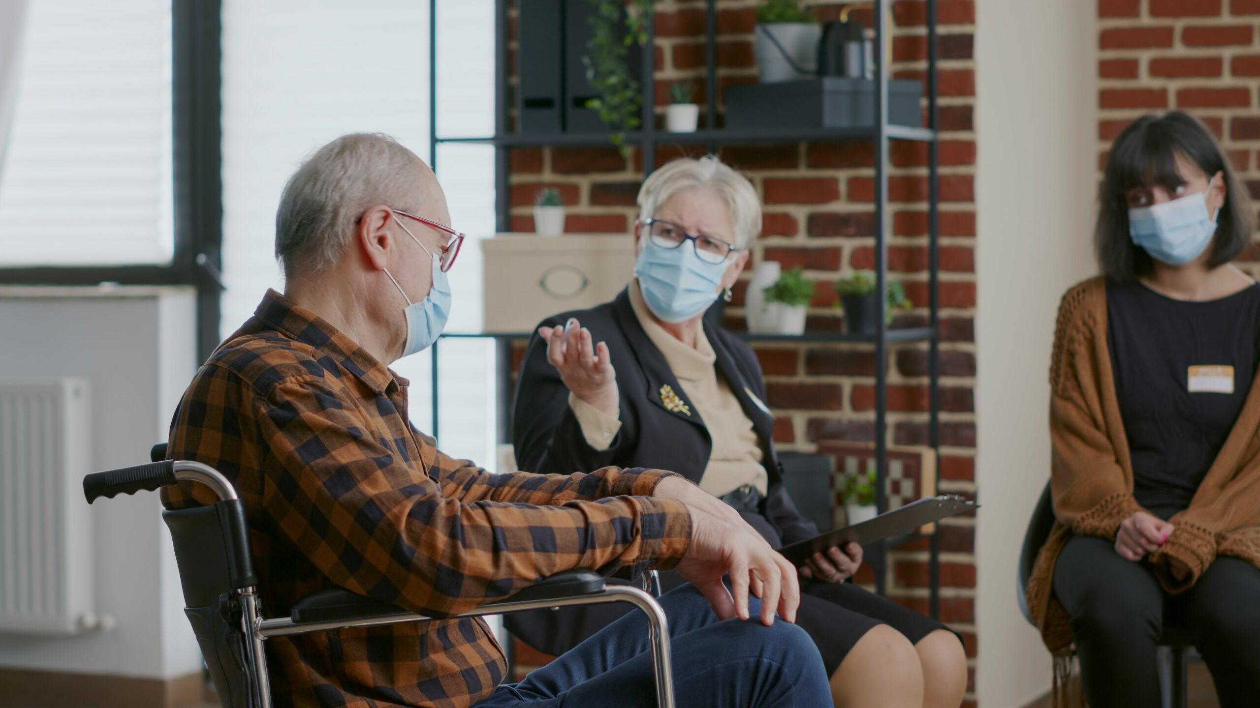 close-up-of-senior-man-sitting-in-wheelchair-and-r-2021-12-09-09-31-35-utc-min-scaled-e1686580192188