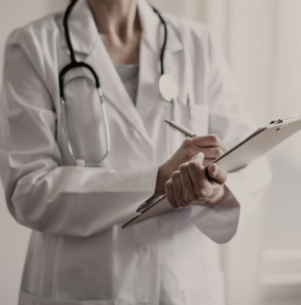 professional-nurse-holding-clipboard A nurse is holding a clipboard while inscribing something on it.